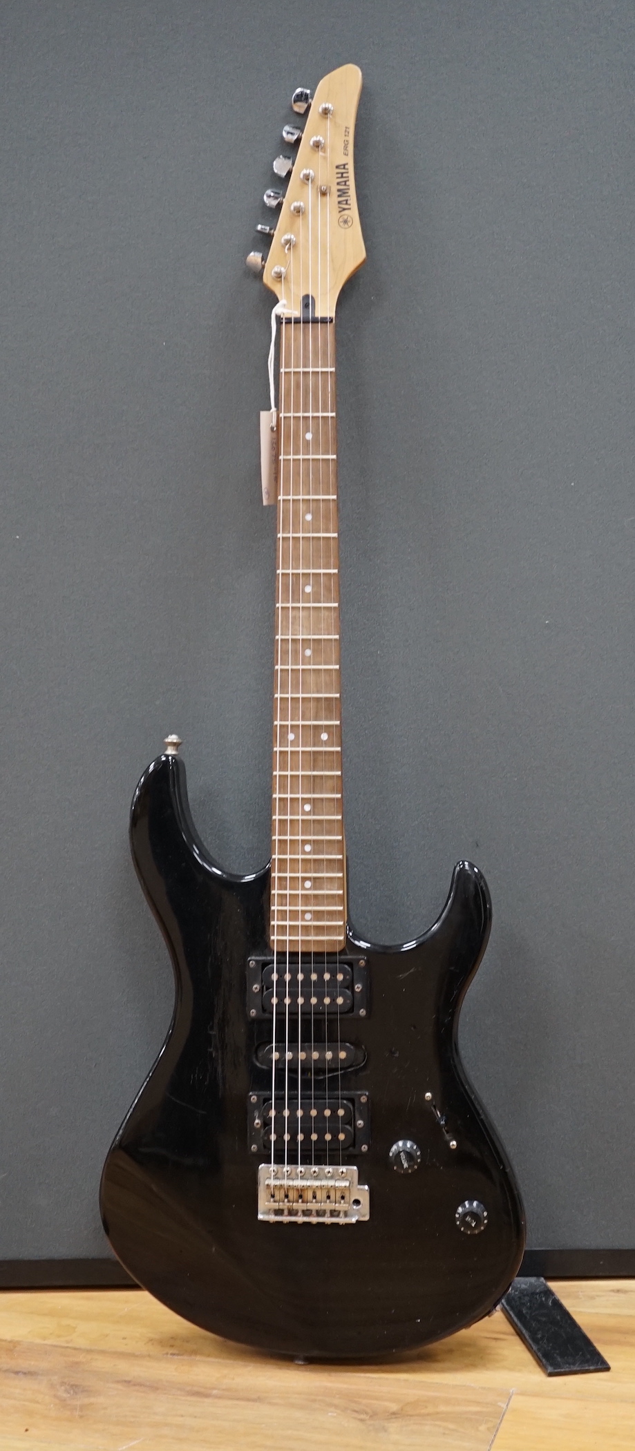 A Yamaha electric guitar, ERG 121, with black lacquer body and a small Carlsbro Kickstart practice amp